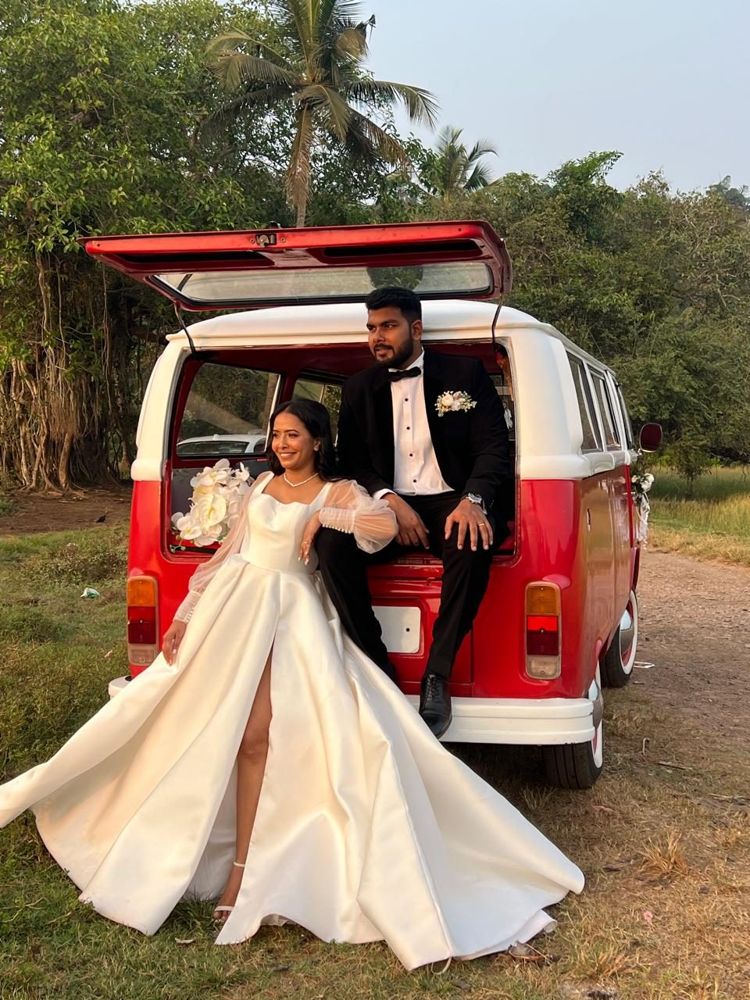 Couple at the open tailgate of the VW Bay Window