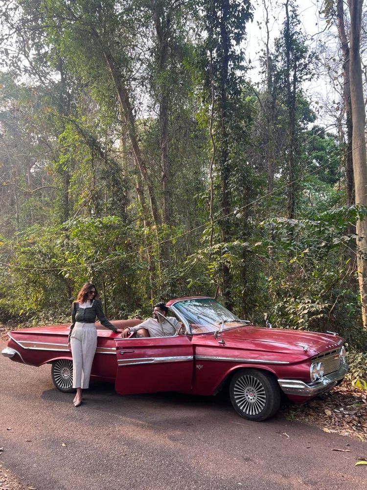 Couple with the burgundy Impala in the forest