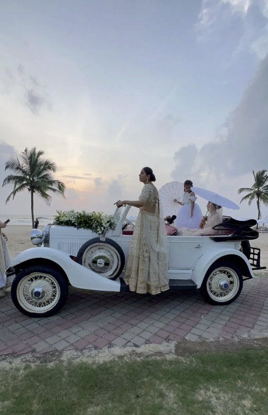Family with parasols in the white tourer on a beach promenade